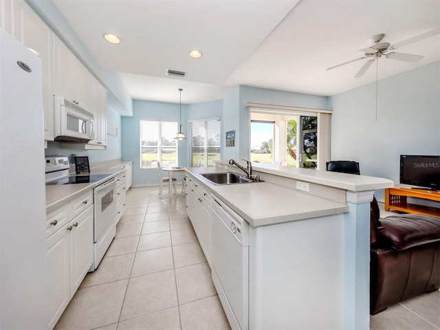 kitchen with hanging light fixtures, white appliances, light countertops, and white cabinets