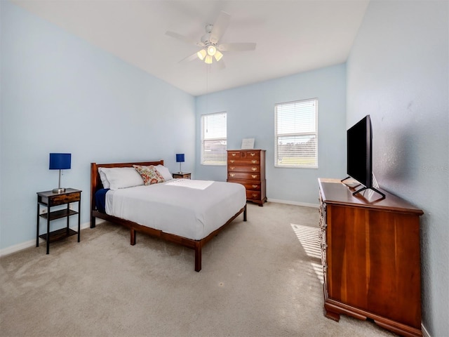 bedroom with baseboards, a ceiling fan, and light colored carpet