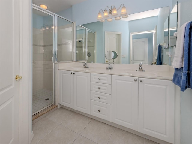 full bathroom featuring a stall shower, tile patterned flooring, and a sink