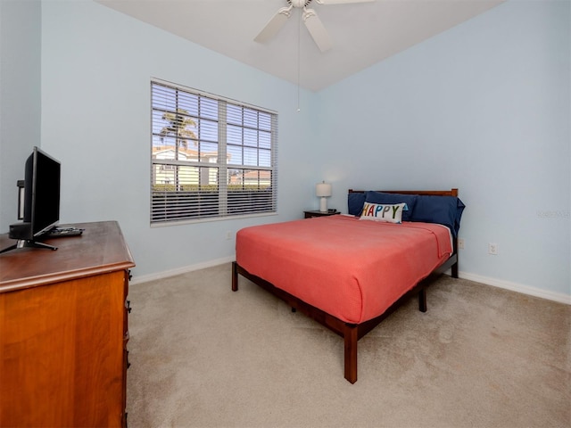 bedroom with light carpet, ceiling fan, and baseboards