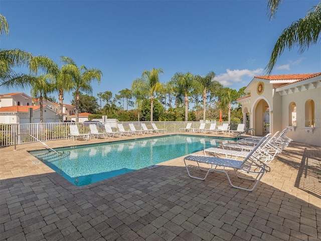 pool featuring a patio area and fence