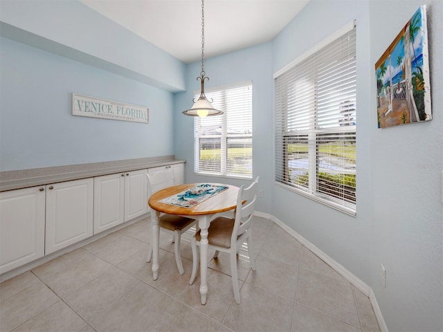 dining room with light tile patterned floors and baseboards