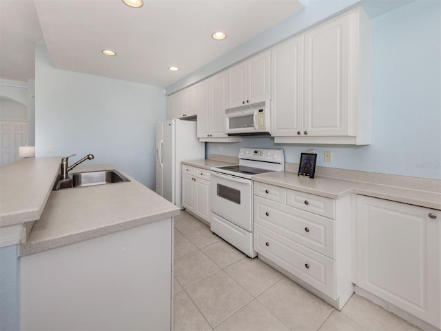 kitchen with recessed lighting, white appliances, a sink, white cabinets, and light countertops