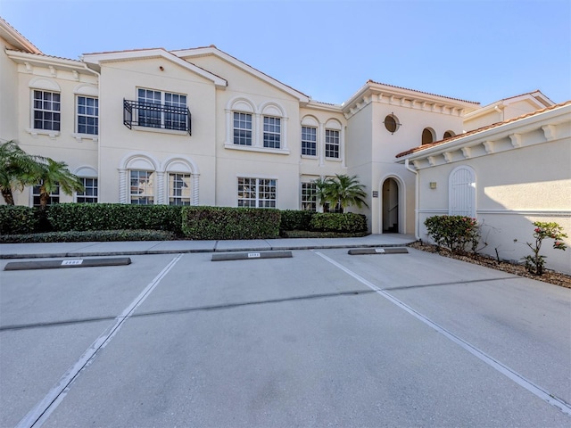 exterior space with uncovered parking and stucco siding