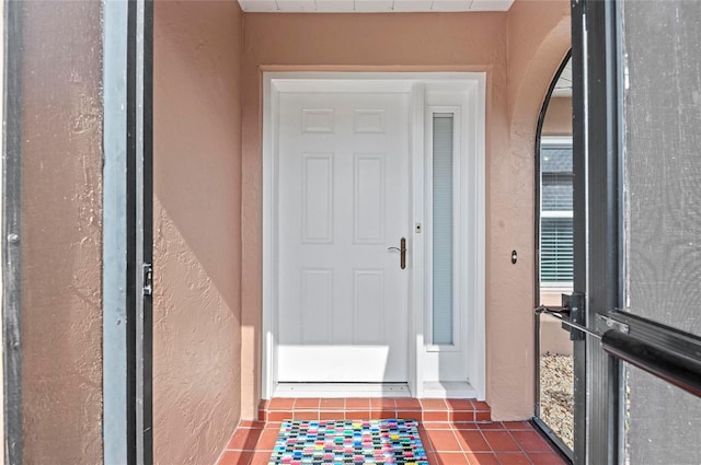 property entrance with stucco siding