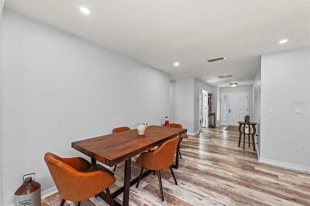 dining area with baseboards, light wood finished floors, visible vents, and recessed lighting