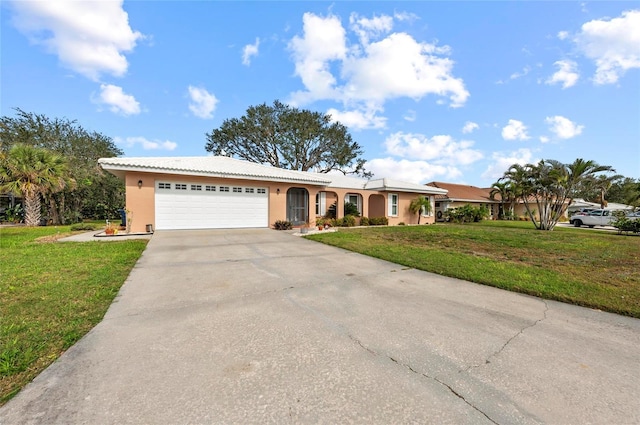 ranch-style home with a garage, driveway, a front lawn, and stucco siding