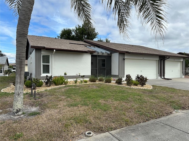 view of front of home featuring stucco siding, concrete driveway, an attached garage, central AC unit, and a front lawn