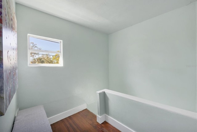 interior space featuring dark wood-type flooring and baseboards