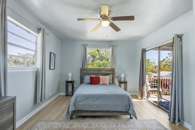 bedroom featuring access to exterior, light wood-type flooring, baseboards, and a ceiling fan