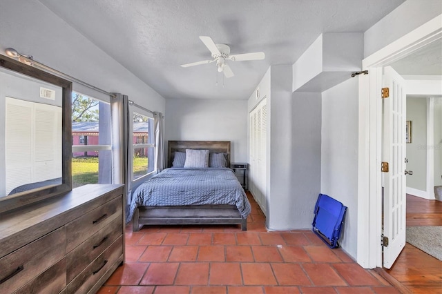 bedroom with a ceiling fan, a closet, and a textured ceiling