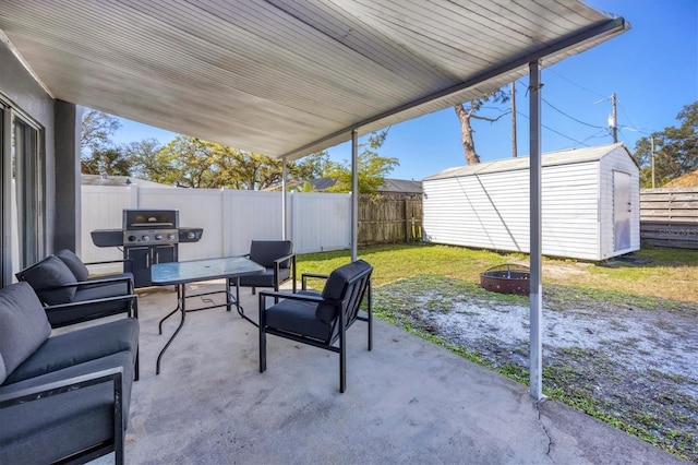 view of patio with an outdoor living space with a fire pit, area for grilling, a fenced backyard, a storage unit, and an outdoor structure