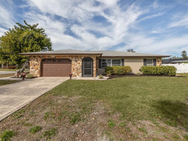 single story home with stucco siding, an attached garage, a front yard, stone siding, and driveway