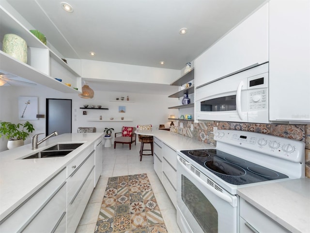 kitchen featuring open shelves, white appliances, and light countertops