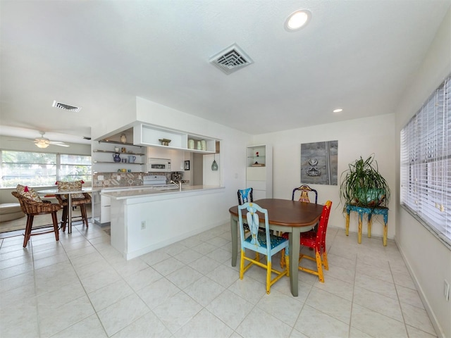 dining area featuring light tile patterned flooring, visible vents, and baseboards