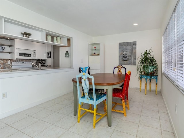 dining room with light tile patterned floors, baseboards, and recessed lighting