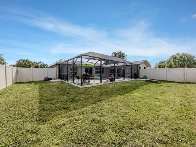 view of yard featuring a gate, a fenced backyard, an outdoor pool, and a lanai