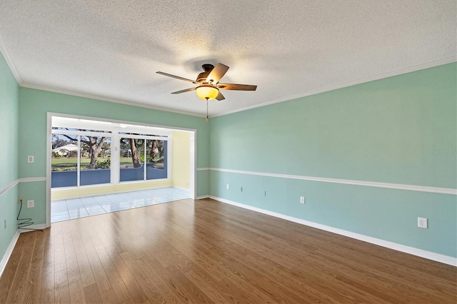 unfurnished room with baseboards, ceiling fan, ornamental molding, wood finished floors, and a textured ceiling