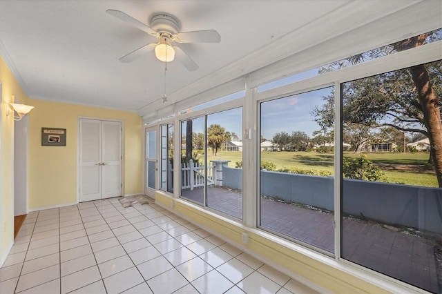 unfurnished sunroom featuring a ceiling fan