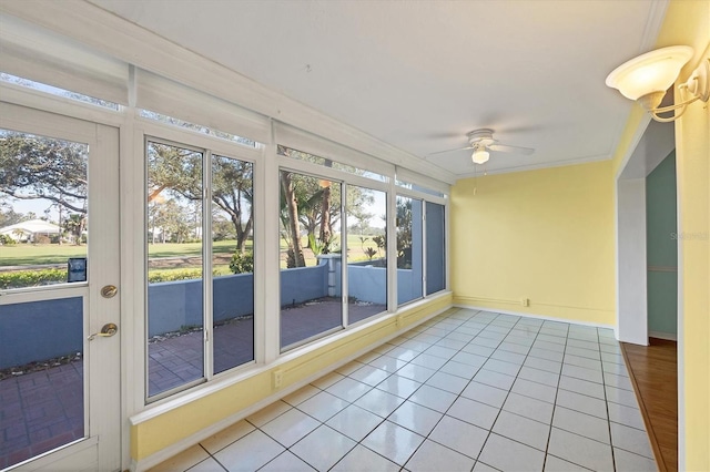 unfurnished sunroom with ceiling fan