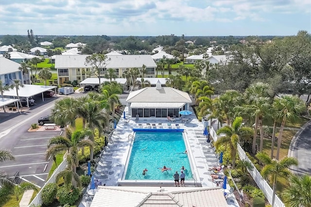 pool with a residential view, fence, and a patio