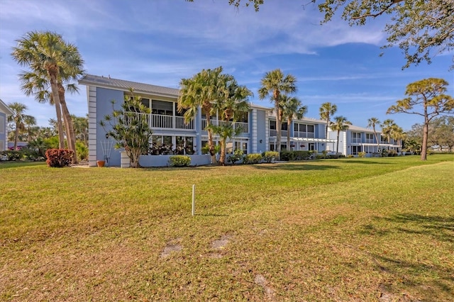 454 Cerromar Rd Unit 174, Venice, FL 34293 - rear view of house with a lawn and metal roof