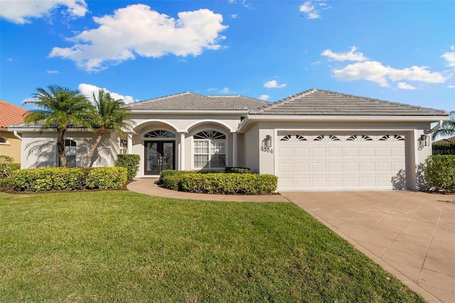 ranch-style house featuring driveway, a tiled roof, an attached garage, and stucco siding