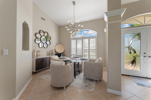 dining area with lofted ceiling, visible vents, a notable chandelier, and light tile patterned floors