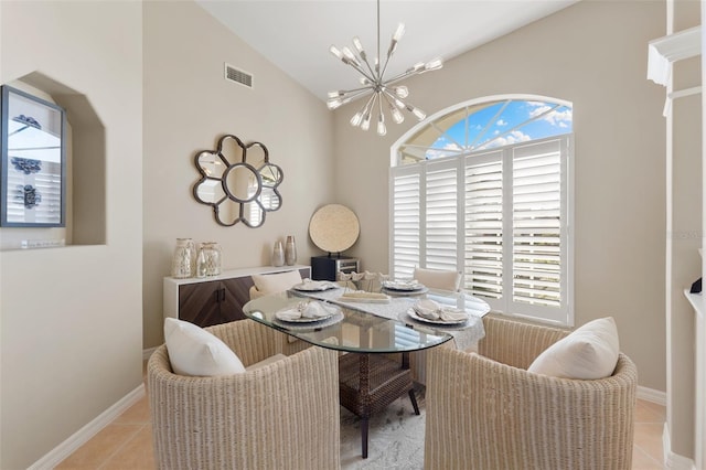 dining space with a chandelier, vaulted ceiling, light tile patterned flooring, and a wealth of natural light