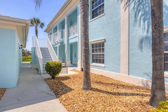 view of home's exterior featuring stairway and stucco siding