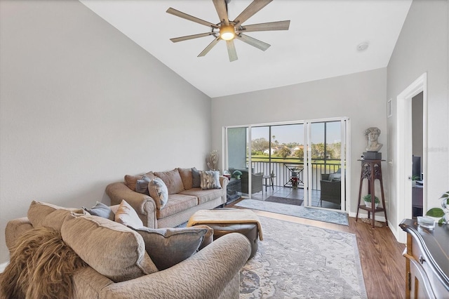 living room featuring ceiling fan, high vaulted ceiling, wood finished floors, and baseboards