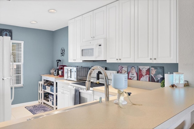 kitchen featuring light countertops, white appliances, a toaster, and white cabinets