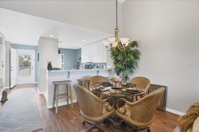 dining room featuring recessed lighting, a notable chandelier, baseboards, and wood finished floors