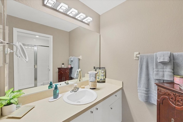 bathroom with a stall shower and vanity