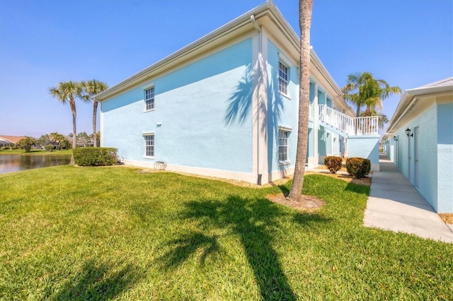 view of property exterior featuring a yard and stucco siding