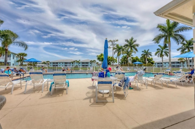 community pool featuring a patio area and fence