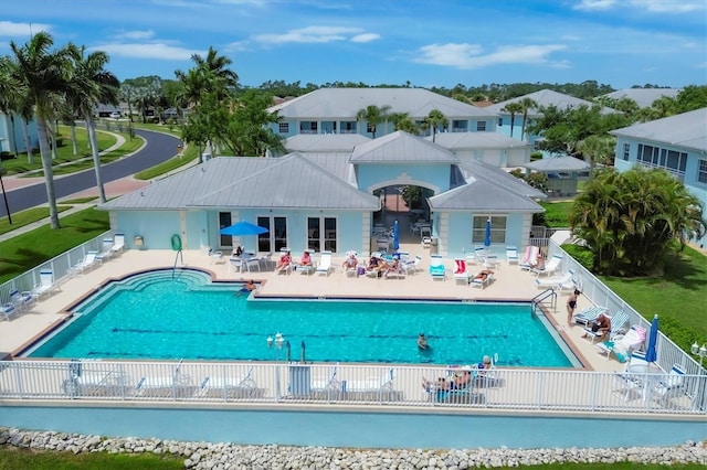 community pool featuring a patio area and fence