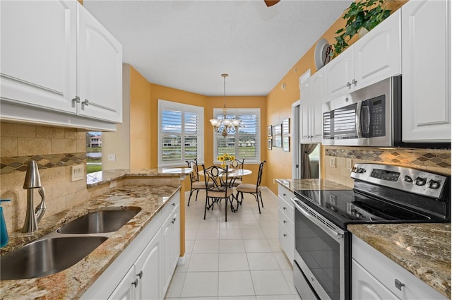 kitchen featuring stainless steel appliances and white cabinetry