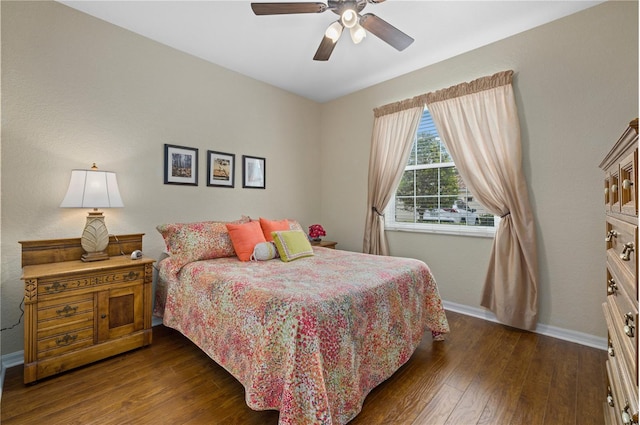 bedroom featuring dark wood-style flooring, ceiling fan, and baseboards