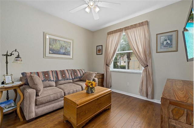 living room with a ceiling fan, dark wood-style flooring, and baseboards