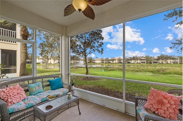 sunroom featuring ceiling fan and a residential view