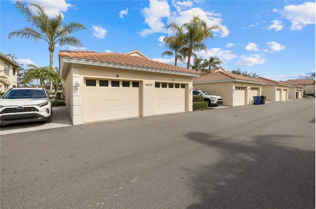 view of front of property featuring stucco siding and community garages