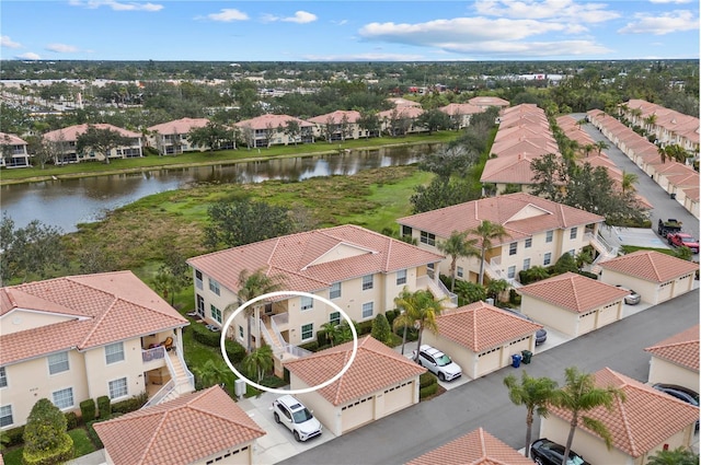 drone / aerial view with a residential view and a water view