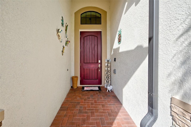 view of exterior entry with stucco siding