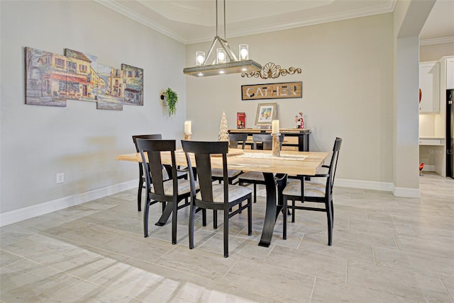 dining space featuring baseboards, ornamental molding, and a notable chandelier