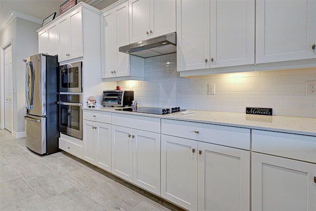 kitchen with decorative backsplash, light stone counters, under cabinet range hood, black appliances, and white cabinetry