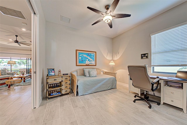 bedroom with baseboards, light wood-style flooring, visible vents, and a ceiling fan