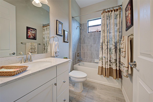 full bathroom featuring toilet, shower / bath combination with curtain, and vanity