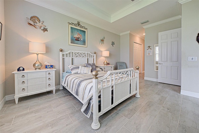 bedroom with a tray ceiling, a closet, visible vents, ornamental molding, and baseboards