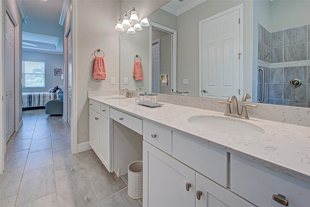 full bathroom with ensuite bathroom, double vanity, a sink, and a tile shower